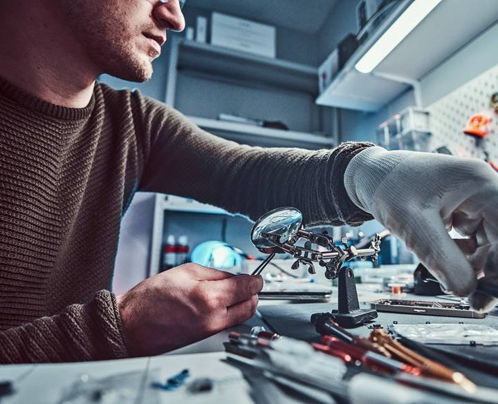 Electronic technician working in the modern repair shop